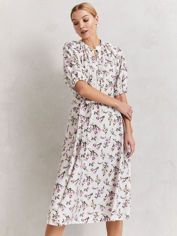 White printed midi length dress with voluminous sleeves and stand-up collar