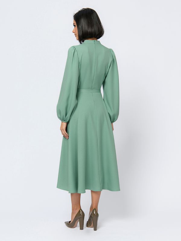 Pistachio colored midi length dress with voluminous sleeves and slit