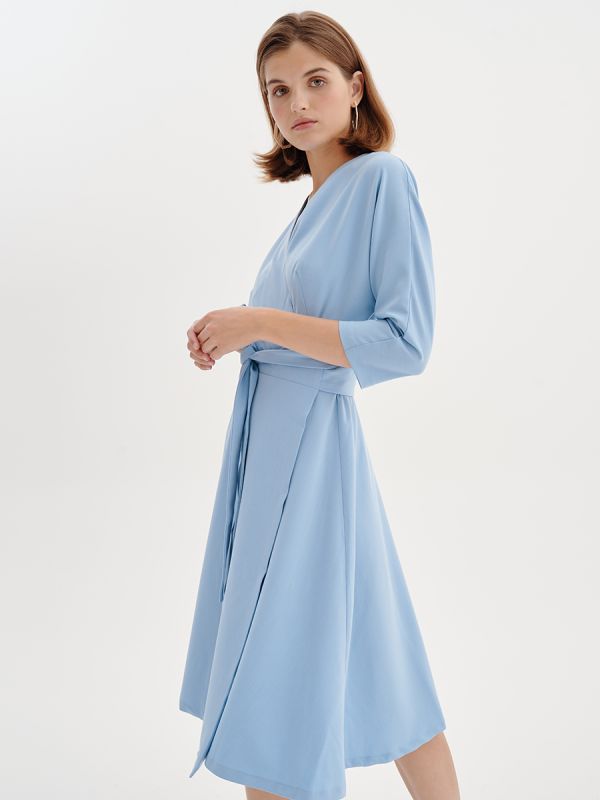 Midi length blue dress with 3/4 sleeves and flap