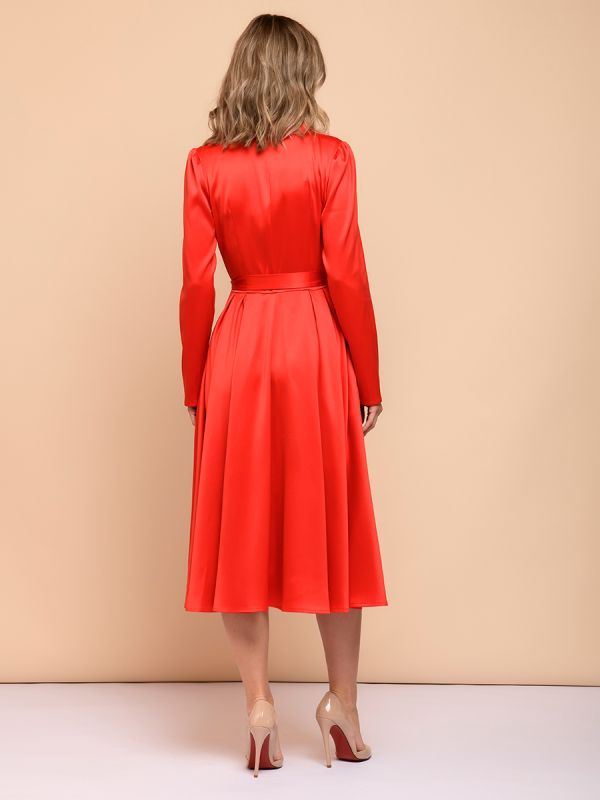 Red midi length dress with voluminous shoulders and long sleeves