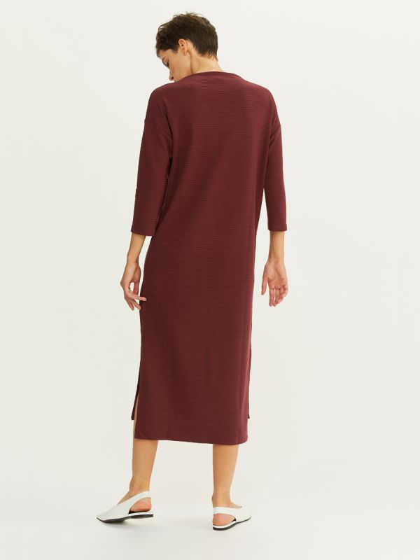 Midi length burgundy dress with 3/4 sleeves and slits on the sides