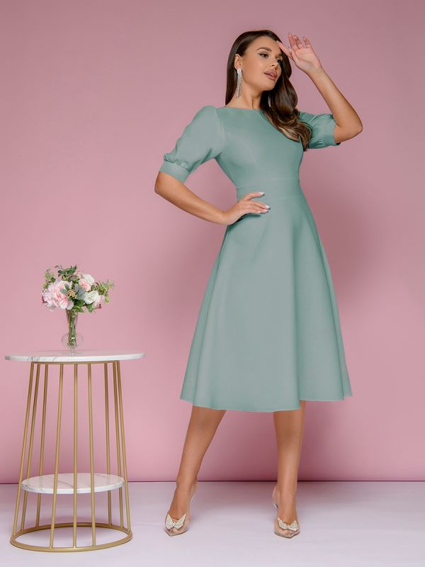 Mint colored midi length dress with shaped back neckline