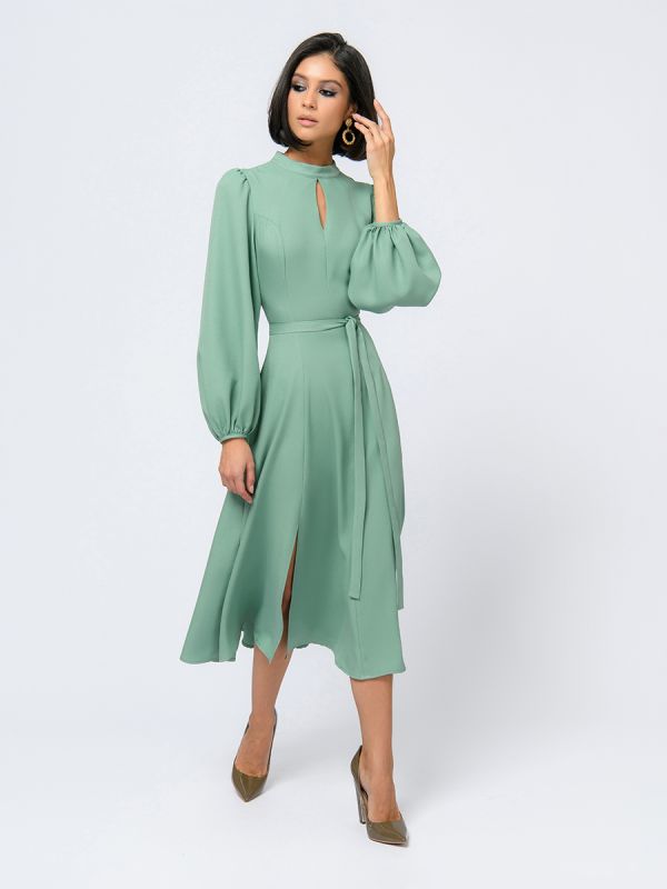 Pistachio colored midi length dress with voluminous sleeves and slit