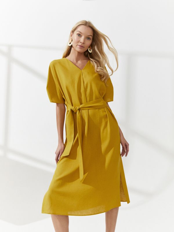 Mustard colored midi length dress with slits on the sides