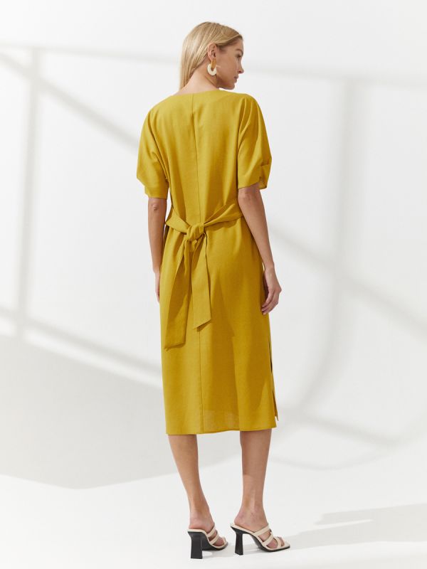 Mustard colored midi length dress with slits on the sides